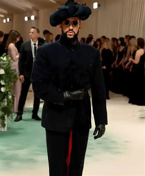 Bad Bunny walked the 2023 Met Gala red carpet solo amid his romance with Kendall Jenner. The 29-year-old rapper donned a white, backless custom Jacquemus suit with a train of roses trailing from ...